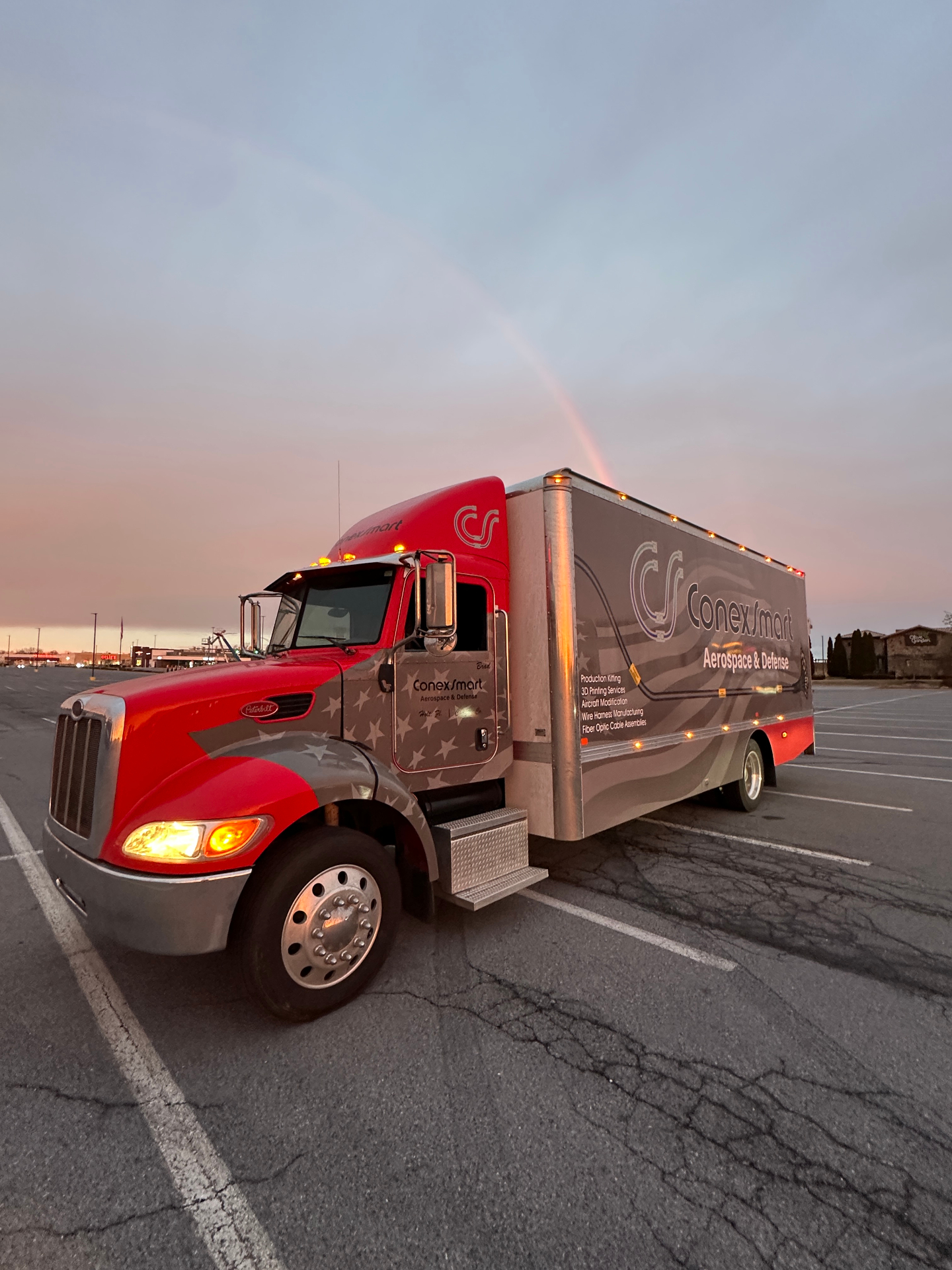 RAMONA truck parked under a rainbow